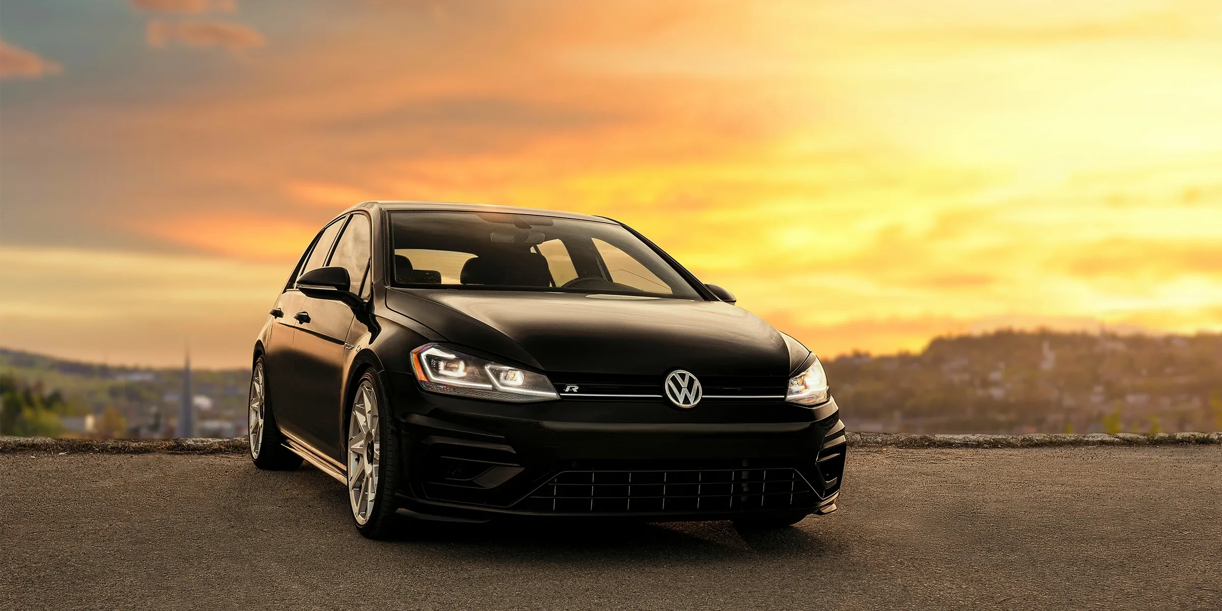 Black VW Golf R at golden hour